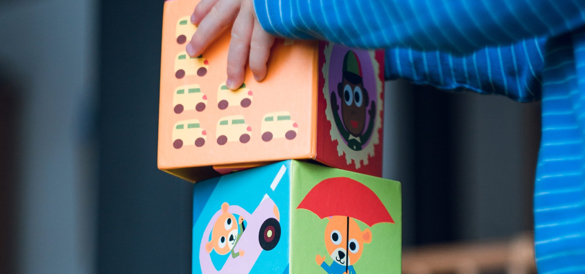 a young child stacking blocks
